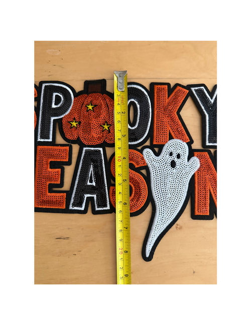 The bold orange, black, and white embroidery creates a classic Halloween look, while the playful pumpkin and adorable ghost give it just the right amount of personality.