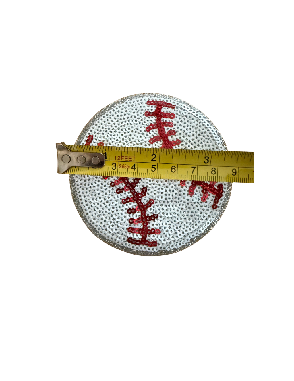 Step up your game-day style with this sparkling Sequin Baseball Patch! Covered in shimmering white sequins with bold red stitched seams and a glittery silver border, this patch takes the classic baseball look