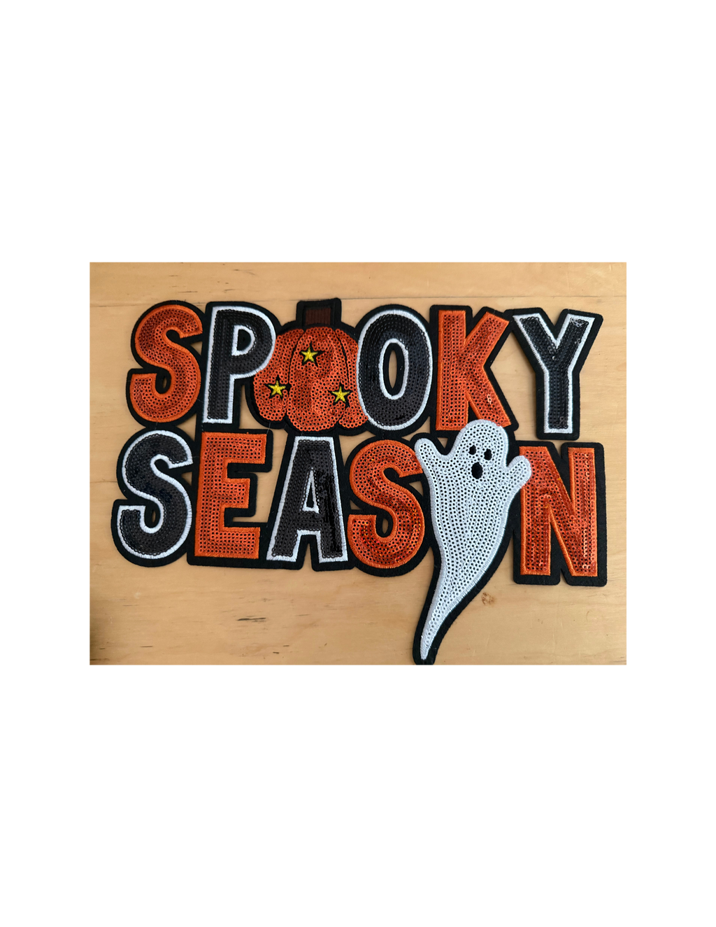 The bold orange, black, and white embroidery creates a classic Halloween look, while the playful pumpkin and adorable ghost give it just the right amount of personality.