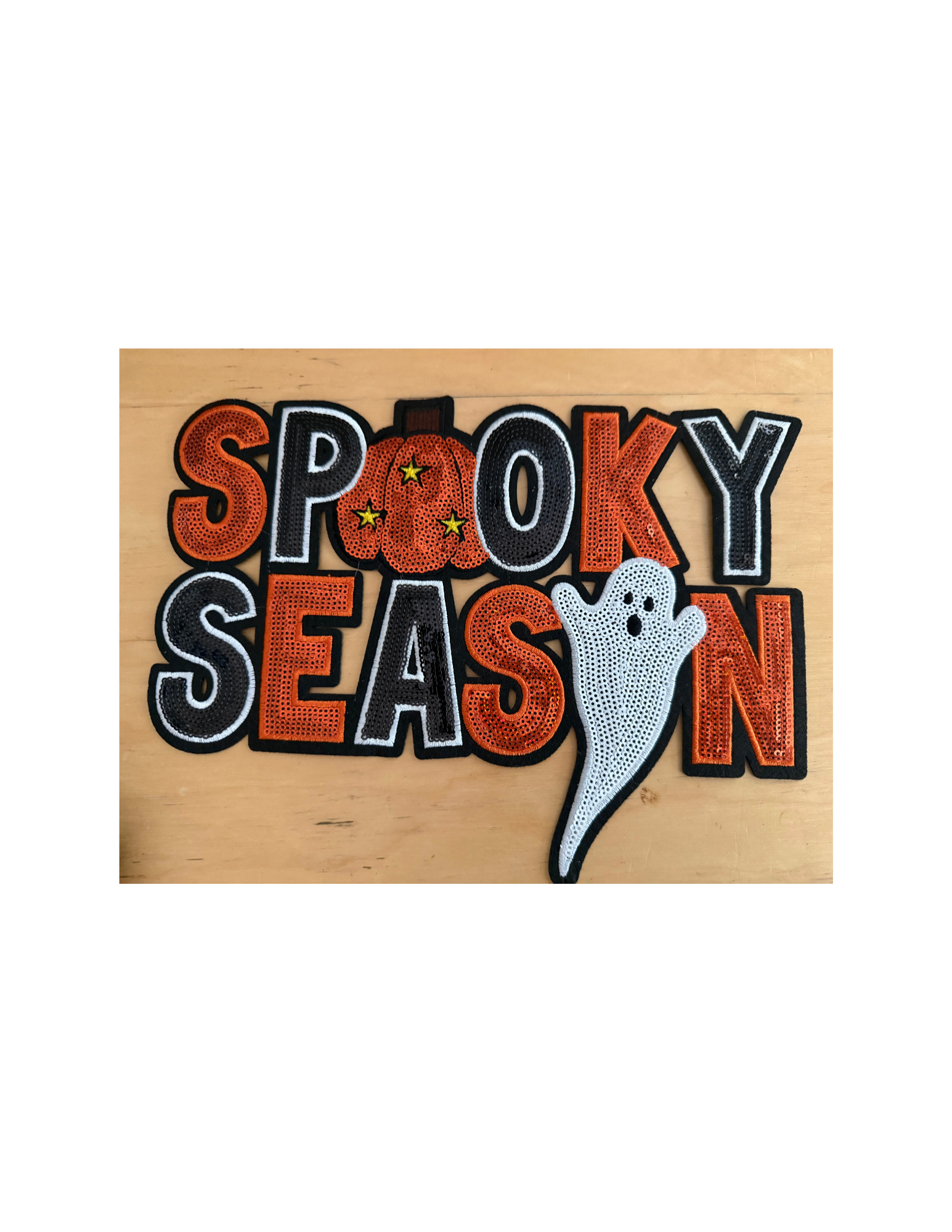 The bold orange, black, and white embroidery creates a classic Halloween look, while the playful pumpkin and adorable ghost give it just the right amount of personality.